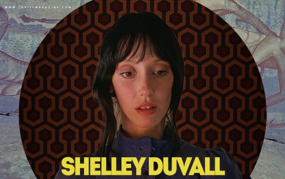 A famous dark haired film actress from the 1970s and 80s looks down towards her own name atop the background of one of her most iconic movies.