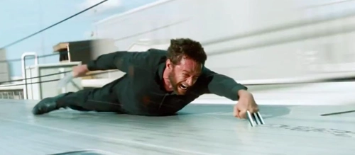 High Jackman clings to a bullet train using only his mutant superhero's metal claws.