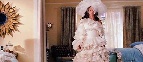 Maya Rudolph test-wears an extravagant wedding dress in 'Bridesmaids' (2011).